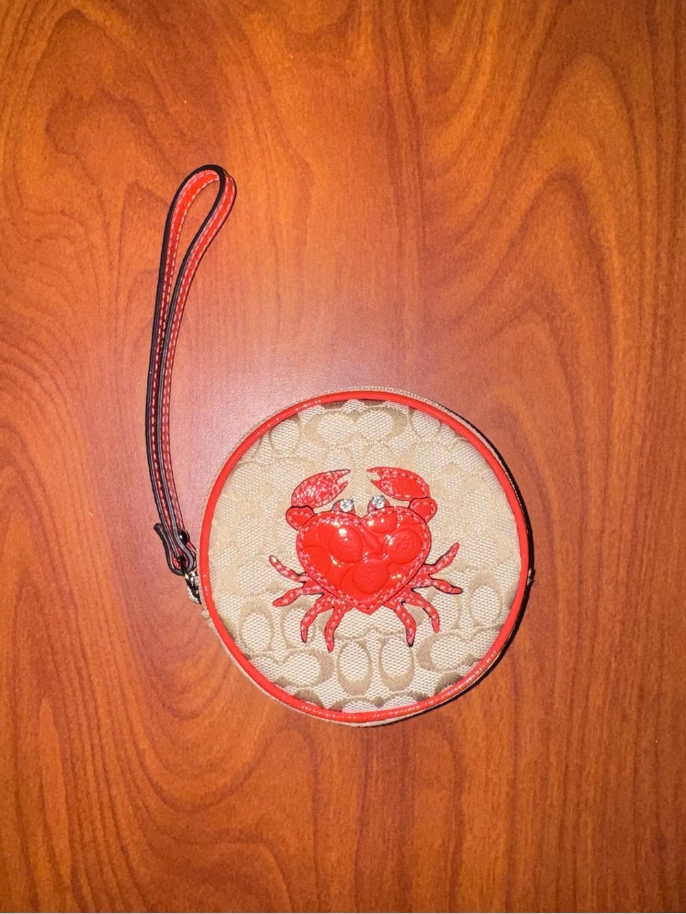 Coach Beige Signature Round Wristlet with Red Crab Appliqué
